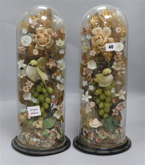 A pair of mid Victorian glass, fabric and metal foil vases of fruit and flowers, under glass dome